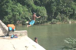 Children jumping off bridge